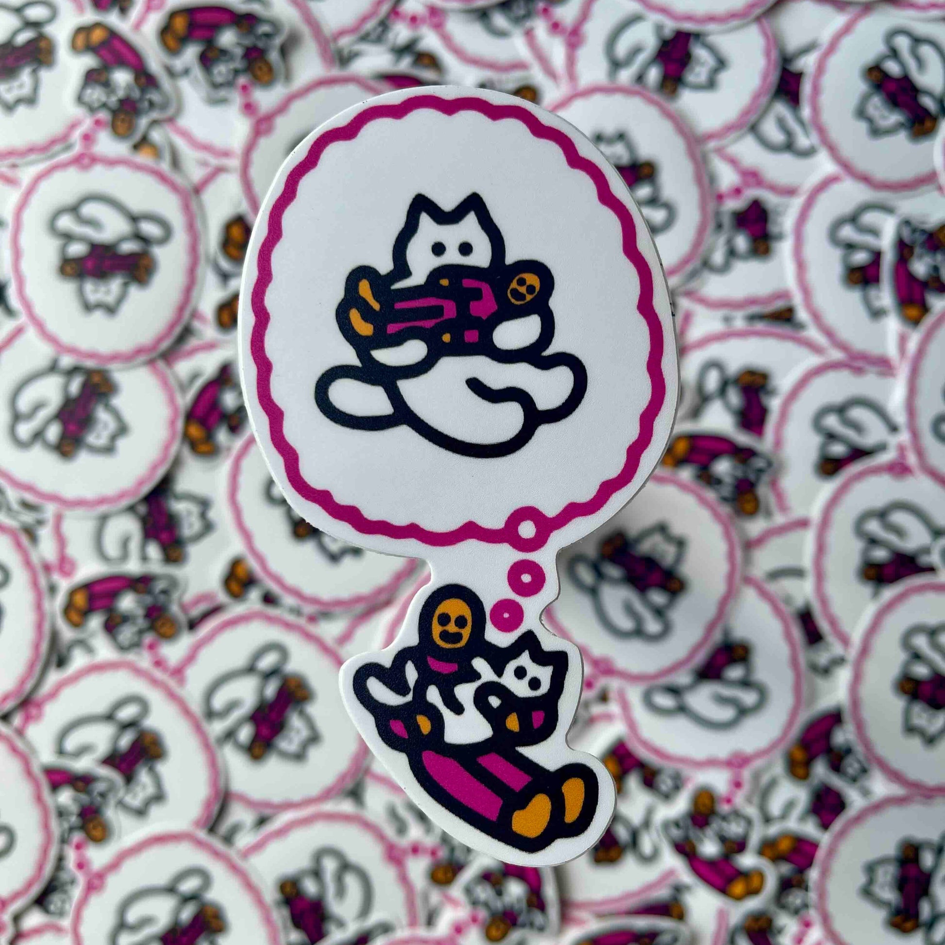 A die-cut sticker featuring a cartoon cat in a pink outfit with a purple thought bubble above it, placed on top of a background of many similar blurred stickers.