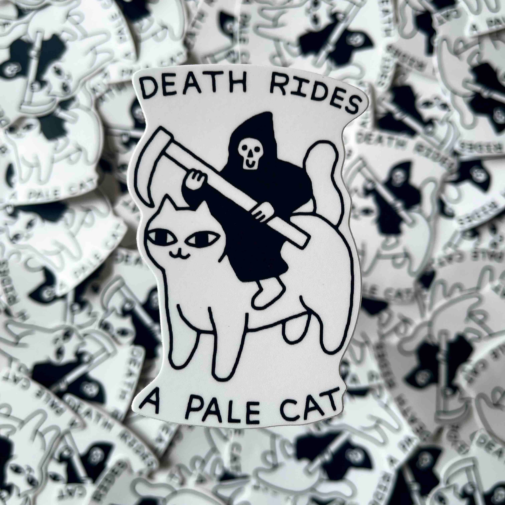 A die-cut sticker featuring a black and white illustration of the Grim Reaper riding a pale cat, with the text 'DEATH RIDES A PALE CAT' on a white background surrounded by a pile of identical stickers.